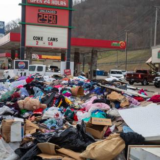 Clothing and debris piled next to a gas station
