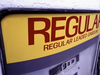 An old gasoline pump that reads: regular leaded gasoline.