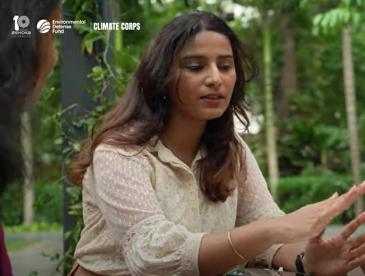 A former Climate Corps fellow works at a computer outdoors.