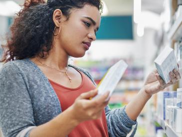 Woman shopping for product in drug store