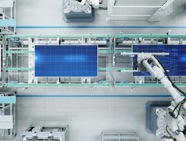 Robotic arm in an assembly line working on solar panels