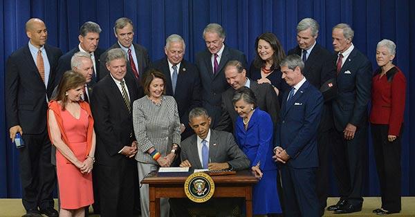 President Obama with other lawmakers signing the Lautenberg Act